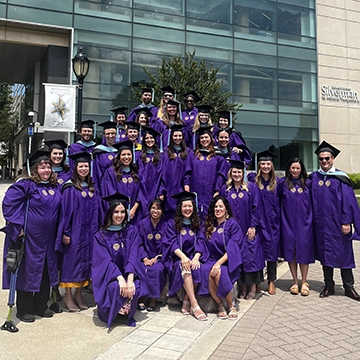 group of graduates in purple robes