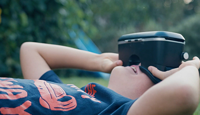 Young person looking through virtual reality goggles