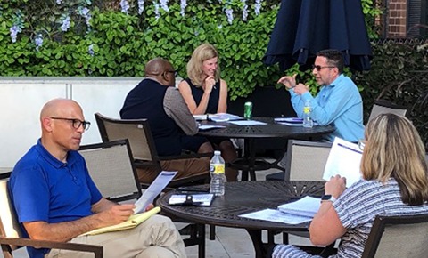 A group of people sitting around a round table