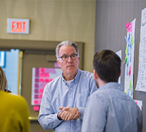 group with wall of post it notes