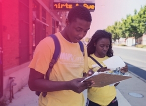 two people looking at a clipboard