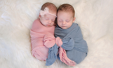 Twin babies wrapped and pink and blue